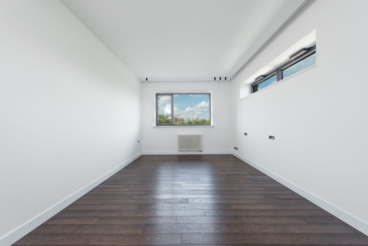 Unfurnished room with white walls, windows, and clean wood flooring